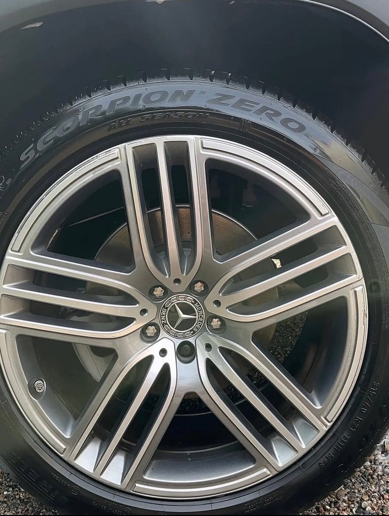 Close-up of silver alloy wheel with Pirelli Zero tire and Mercedes-Benz center cap on vehicle